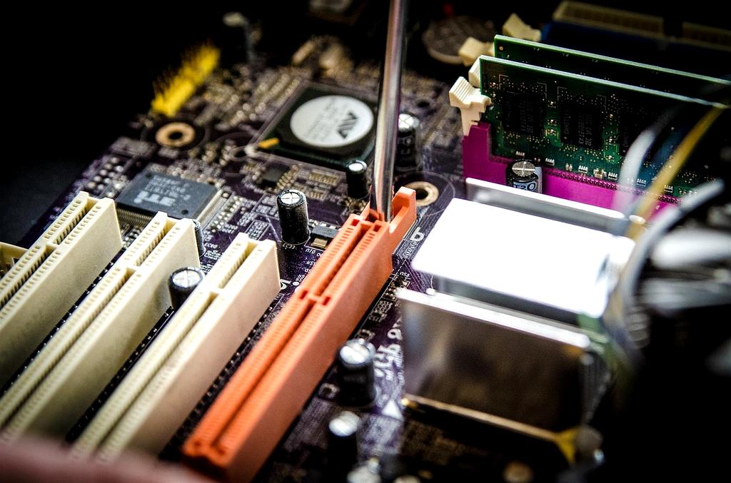 Professional computer repair workspace with diagnostic tools and motherboard components